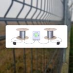 IRONCLAD fence alarm system controller mounted on a chain-link perimeter fence