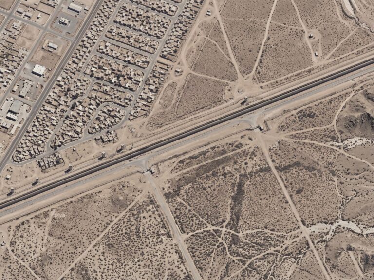 Aerial view of a monitored border corridor with a patrol road