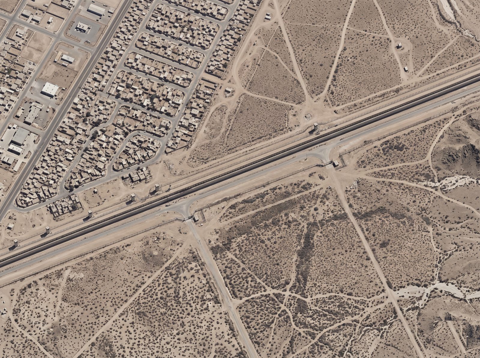 Aerial view of a monitored border corridor with a patrol road