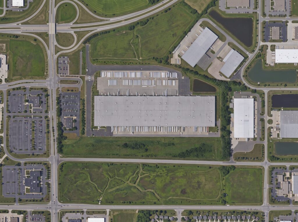 Aerial view of a distribution and fulfillment centre with a fenced trailer yard