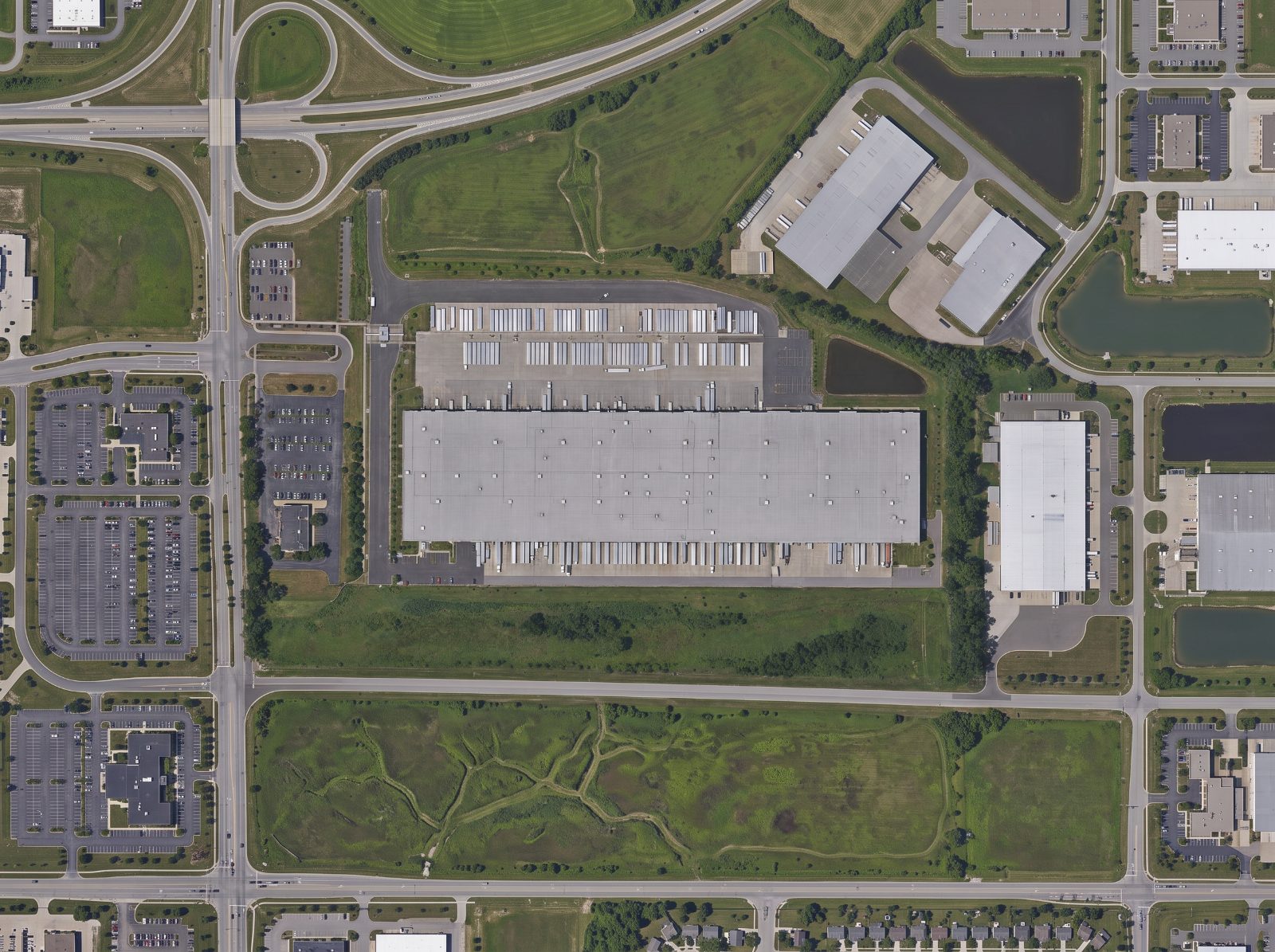 Aerial view of a distribution and fulfillment centre with a fenced trailer yard