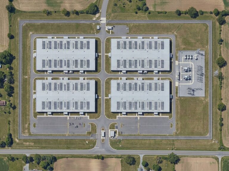 Aerial view of a secure data center campus with a fenced perimeter