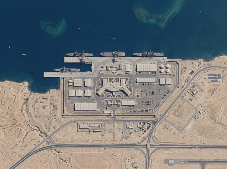 Aerial view of a sea port with docked ships and container yards