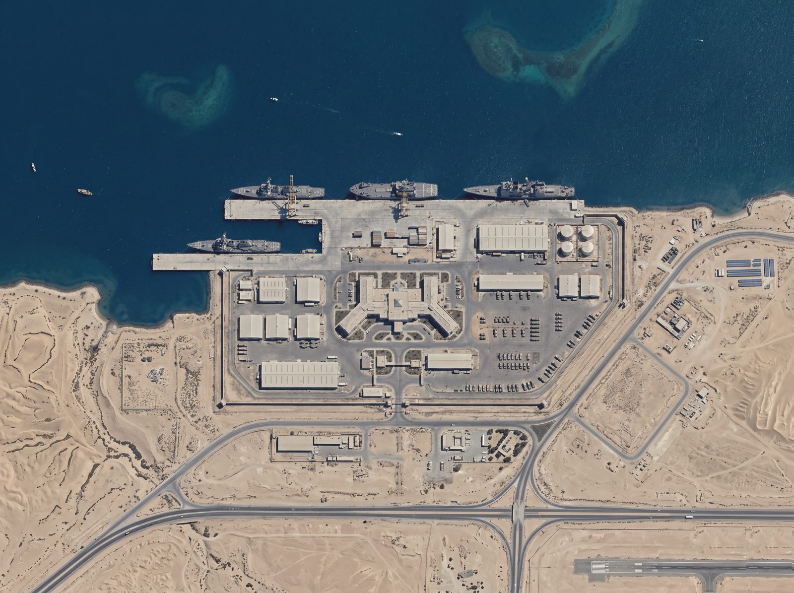 Aerial view of a sea port with docked ships and container yards