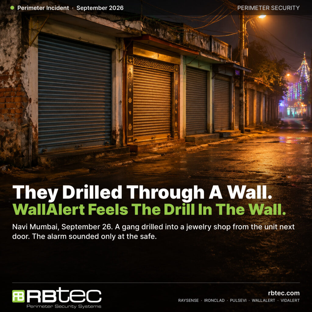 Illustrative night view of a lane of small shops with closed steel shutters and shared masonry walls, festival lights in the distance